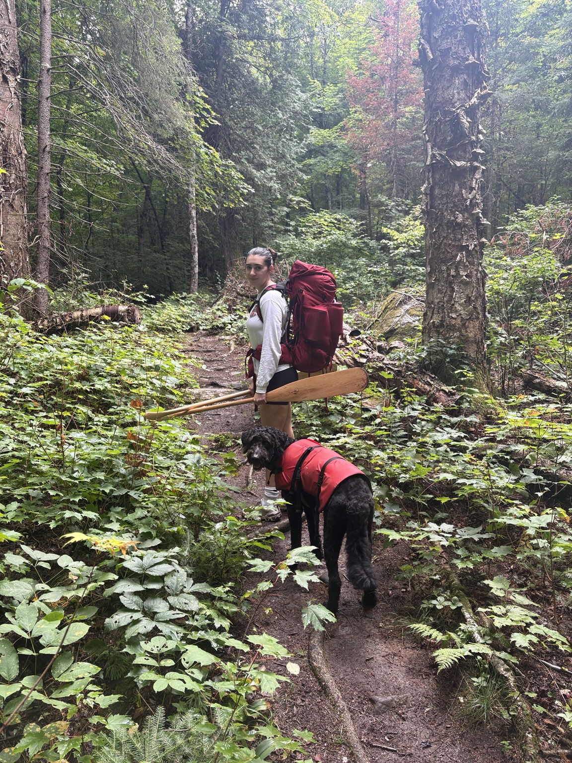 Claudia and their dog on a forest adventure